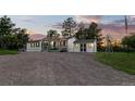 Exterior view of the home featuring a windmill, outbuilding and gravel driveway at 652 Verdos Dr, Elizabeth, CO 80107