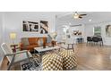 Inviting living room featuring hardwood floors, a leather sofa and neutral colored decor at 652 Verdos Dr, Elizabeth, CO 80107