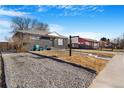 Home featuring gravel yard, dark exterior, and inviting front porch at 1381 Mariposa Dr, Denver, CO 80221