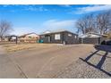 Home featuring a private driveway leading to a garage with basketball hoop at 1381 Mariposa Dr, Denver, CO 80221