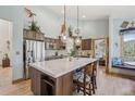 Bright kitchen boasts a large center island, stainless steel appliances, and wood cabinets at 30206 Telluride Ln, Evergreen, CO 80439