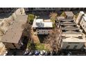 Aerial view of a home's backyard including trees, grass, and parking for many cars, surrounded by other buildings at 1749 Boulder St, Denver, CO 80211