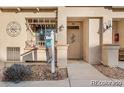 Close up of the entrance to a townhome featuring a porch and drought tolerant landscaping at 833 E 98 Ave # 204, Thornton, CO 80229