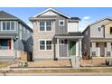 Two-story craftsman style home with light gray and stone accents at 21239 E 62Nd Ave, Aurora, CO 80019