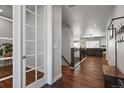 Spacious hallway featuring hardwood floors and a view of the living room beyond at 12938 Bridge View Ln, Parker, CO 80134