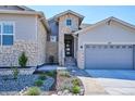 Charming two-story home with a stone facade, landscaped yard, and a two-car garage at 547 Scrubjay Cir, Castle Rock, CO 80104