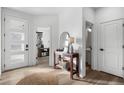 Bright and airy entryway with wood console table, mirror, and view to the living room at 6350 Stable View St, Castle Pines, CO 80108