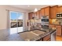 Close up shot of kitchen island with granite countertops and stainless steel appliances at 15625 Carob Cir, Parker, CO 80134