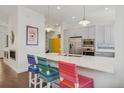 Bright kitchen with a large island, stainless steel appliances, and stylish pendant lighting at 4958 Valentia Ct, Denver, CO 80238