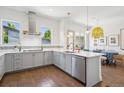 Modern kitchen featuring stainless steel appliances, white quartz countertops, and hardwood flooring at 4958 Valentia Ct, Denver, CO 80238