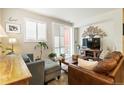 Bright living room featuring a comfortable sofa, accent chair, and decorative wall art at 1640 Aspen Meadows Cir, Federal Heights, CO 80260