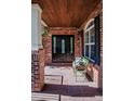 Inviting front porch with brick details and outdoor seating at 693 Syracuse St, Denver, CO 80230
