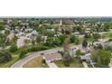Expansive aerial view of a peaceful neighborhood with lush greenery and charming homes and a view of the neighborhood beyond at 107 S Windsor Dr, Denver, CO 80219