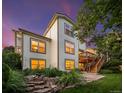 Backyard with green grass, lush landscaping, wooden deck, and stairs for outdoor living at 888 Northern Way, Superior, CO 80027
