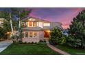 Charming two-story home with brick and siding exterior, lush lawn, and mature trees at twilight at 888 Northern Way, Superior, CO 80027