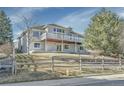 Spacious backyard featuring a large deck, perfect for outdoor entertaining, and a wooden fence at 9232 Bauer Ct, Lone Tree, CO 80124