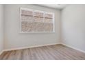 Bright bedroom with wood floors and lots of natural light from the large window at 457 Interlocken Blvd # 106, Broomfield, CO 80021