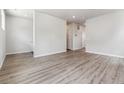 Spacious living room area featuring gray wood-style flooring and neutral paint at 457 Interlocken Blvd # 106, Broomfield, CO 80021