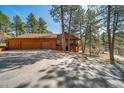 Inviting two-story home with a three-car garage, well-maintained driveway, and natural surroundings at 767 Tenderfoot Dr, Larkspur, CO 80118