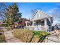 Beautiful home with a covered porch and well-manicured front lawn, great curb appeal at 3931 King St, Denver, CO 80211