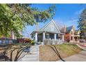 Side view of a cute home with a covered porch, showing off the landscaping and inviting entrance at 3931 King St, Denver, CO 80211