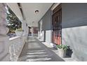 Covered porch with decorative columns and ample space, perfect for enjoying the outdoors at 3931 King St, Denver, CO 80211