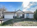 Charming single-story home with a well-manicured lawn and attached two-car garage, exuding curb appeal at 9712 Adams St, Thornton, CO 80229