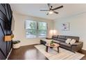 Cozy living room with hardwood floors and natural light from the large windows at 9758 Laredo St # 1E, Commerce City, CO 80022