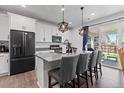 Modern kitchen with stainless steel appliances, a center island with seating, and sliding door to the patio at 140 Vista Cliff Cir, Castle Rock, CO 80104