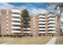 Brick apartment building showcases multiple balconies and well-kept lawns at 2880 S Locust St # 505N, Denver, CO 80222