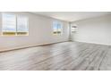 Bright, open living space with three windows provides ample natural light at 4255 Gozzer Ranch Dr, Elizabeth, CO 80107
