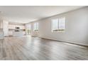 Large living space features an open floor plan connecting the kitchen and living area at 4255 Gozzer Ranch Dr, Elizabeth, CO 80107