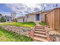Inviting home with stone steps leading to the blue front door at 598 Arden Cir, Highlands Ranch, CO 80126