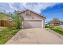 Attached two-car garage with a wide driveway at 598 Arden Cir, Highlands Ranch, CO 80126