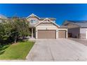 Charming home with a two-car garage and a well-maintained lawn on a beautiful sunny day at 10569 Racine St, Commerce City, CO 80022
