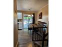 Dining room with wood table, chandelier, and sliding door access to the backyard at 2034 S Truckee St, Aurora, CO 80013