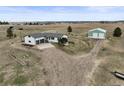 Expansive acreage featuring a charming single-story home with a large garage and a sizable storage building at 2845 Cherry Way, Parker, CO 80138