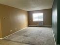 Inviting living room with neutral carpet and a window providing natural light at 707 W 96Th Ave # 9, Thornton, CO 80260