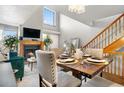 Dining room with high ceilings, a large window for natural light, and a cozy fireplace in the background at 5155 W 68Th Ave # 5, Westminster, CO 80030