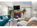Bright living room featuring a fireplace, neutral walls, stylish decor, and comfortable seating arrangement at 5155 W 68Th Ave # 5, Westminster, CO 80030