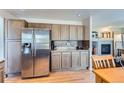 Kitchen boasts stainless steel refrigerator and ample cabinet space at 5416 S Gray St, Littleton, CO 80123