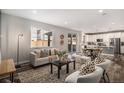 Comfortable living room with an open floor plan, hardwood floors, and sliding door access at 1011 White Leaf Cir, Castle Rock, CO 80108