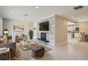 Modern living room features a decorative stone wall with a mounted TV and fireplace at 1701 S Newport Way, Denver, CO 80224