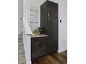 Pantry area featuring modern cabinets and shelving next to staircase at 2857 S Pancratia St, Denver, CO 80236