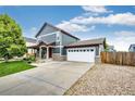 Beautiful home exterior with a large driveway and well-maintained lawn at 1824 Asoka St, Strasburg, CO 80136