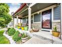 Inviting front porch featuring a cozy seating area and stylish decor at 1824 Asoka St, Strasburg, CO 80136