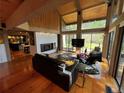 Open concept living room with vaulted ceilings, wood floors, fireplace and bright natural light at 24226 Currant Dr, Golden, CO 80401