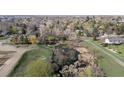 Scenic aerial view of the natural landscape with mature trees and foliage and a peaceful pond at 2949 Vivian St, Wheat Ridge, CO 80215