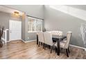Elegant dining room featuring high ceilings, wood floors, and a stylish table set at 14803 E 117Th Pl, Brighton, CO 80603