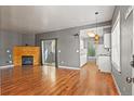 Spacious living room featuring hardwood floors, a fireplace, and sliding glass doors at 8055 W Eastman Pl # 104, Lakewood, CO 80227